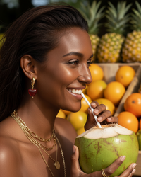 Thumbnail for Woman drinking from a coconut with fruits in the background