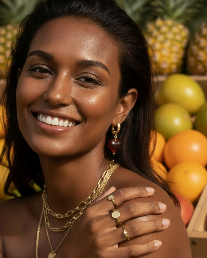 Woman drinking from a coconut with fruits in the background