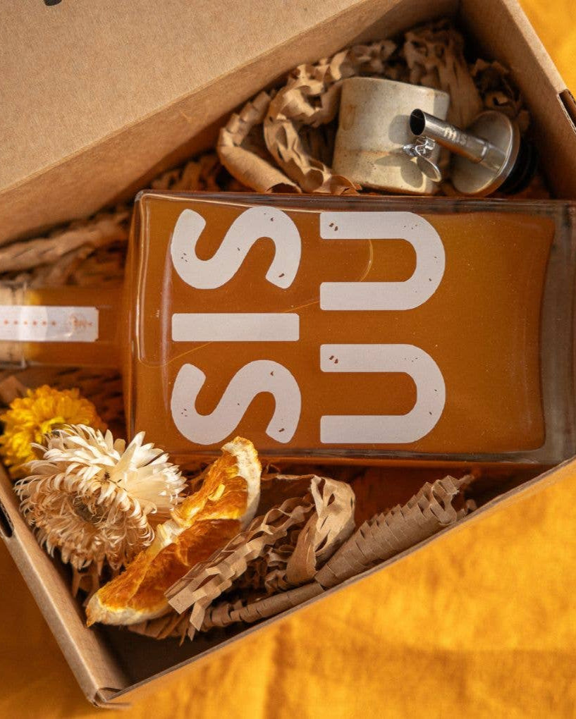 Product with 'SISU' branding in a box with decorative items