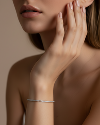Thumbnail for Woman's hand with a silver tennis bracelet on a neutral background