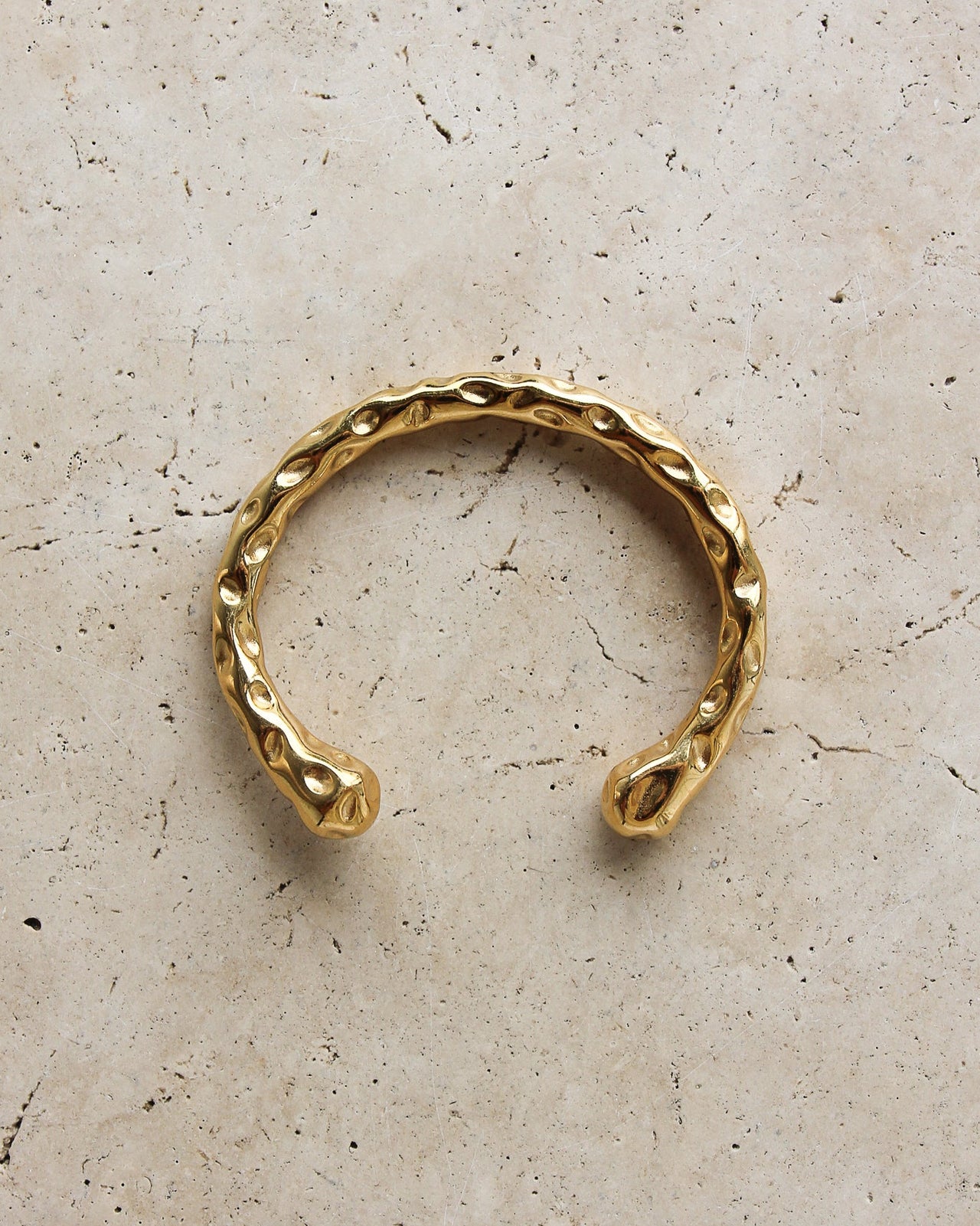 Gold textured cuff bracelet by Tegan Rae Jewelry featuring a stylish, wide metal design with a textured finish.