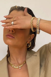Thumbnail for Gold watch link chain bracelet by TEGAN RAE JEWELLERY featuring a sleek, shiny gold-tone design with interconnected chain links.