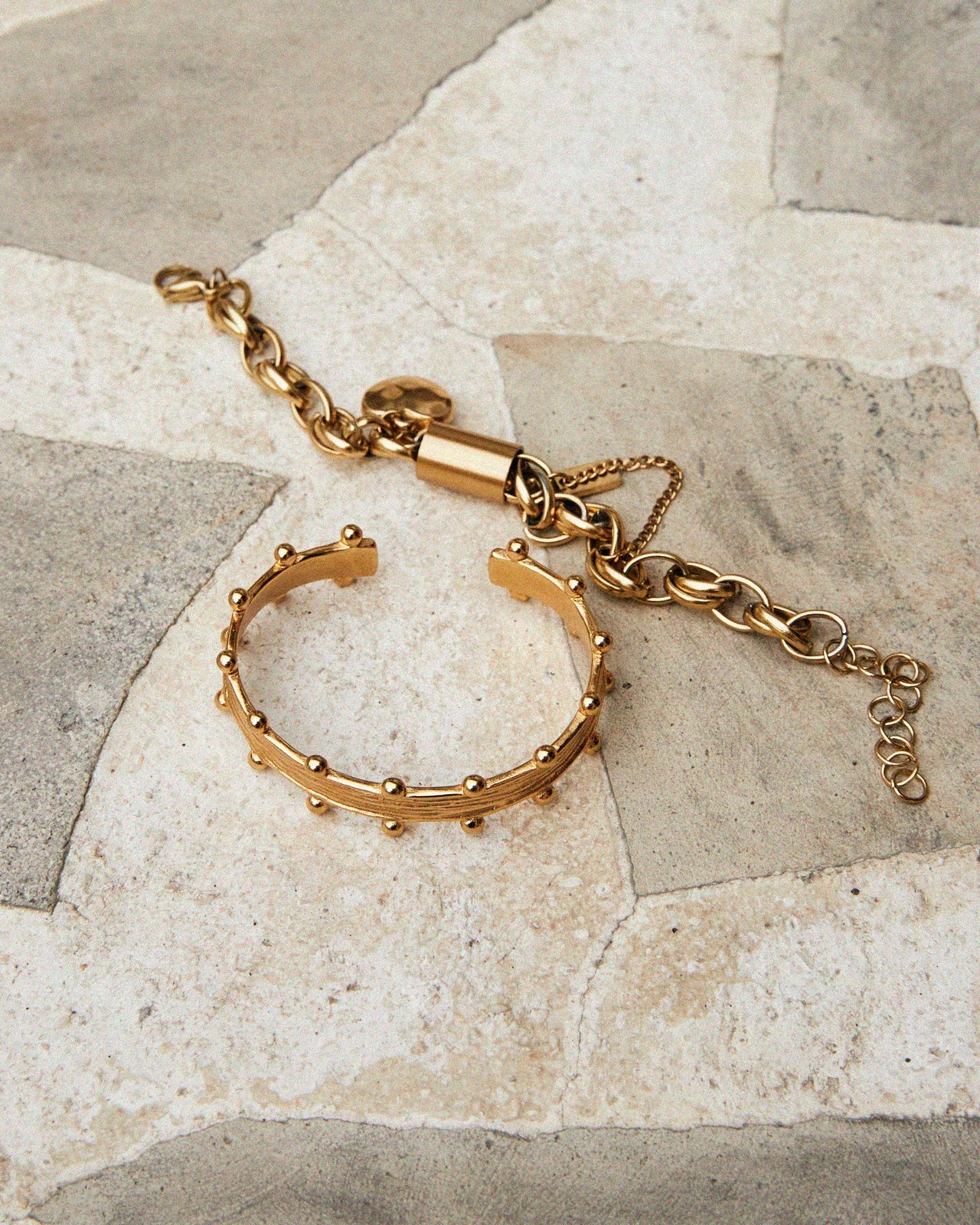 Gold bracelet on a stone surface