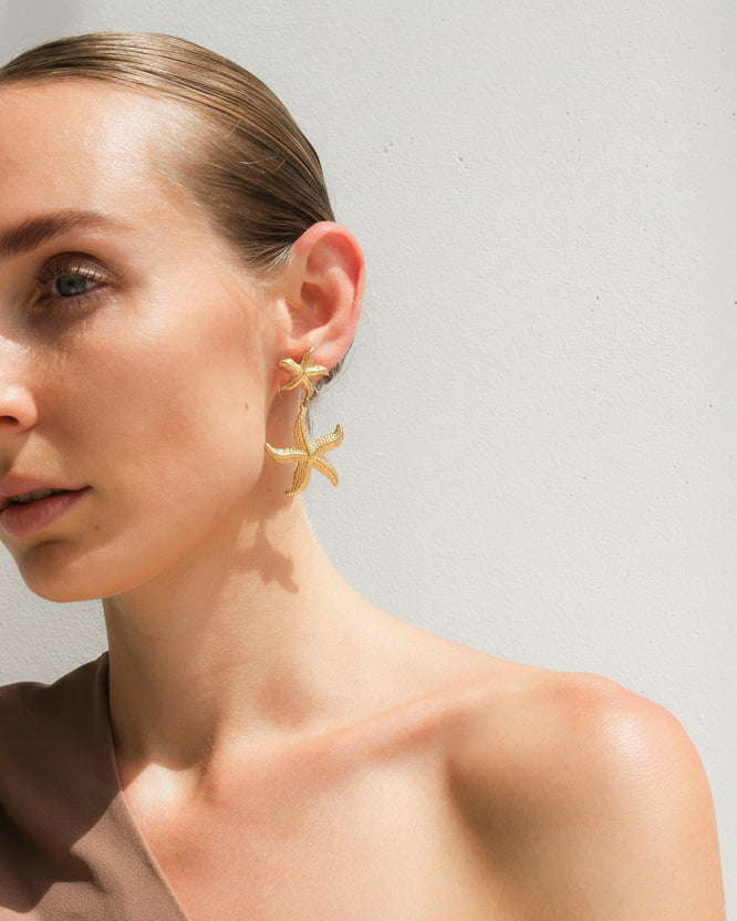 Gold starfish drop earrings by Tegan Rae Jewellery featuring handcrafted marine-inspired design, perfect for beach or casual wear.