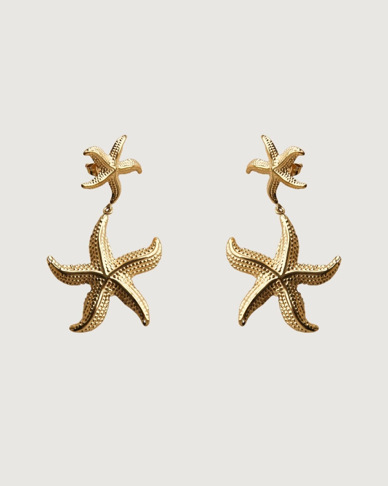 Gold starfish drop earrings by Tegan Rae Jewellery featuring elegant design and shimmering gold finish.