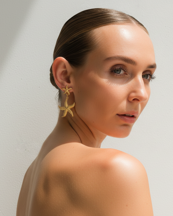 Gold starfish drop earrings from Tegan Rae Jewellery featuring delicate marine-inspired design and shiny gold finish.