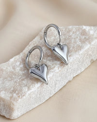 Thumbnail for Silver heart charm hoop earrings by Tegan Rae Jewellery, featuring a stylish and elegant hoop design with heart charms.