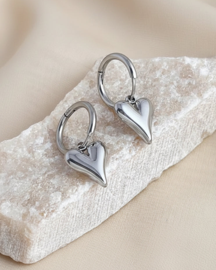 Silver heart charm hoop earrings by Tegan Rae Jewellery, featuring a stylish and elegant hoop design with heart charms.