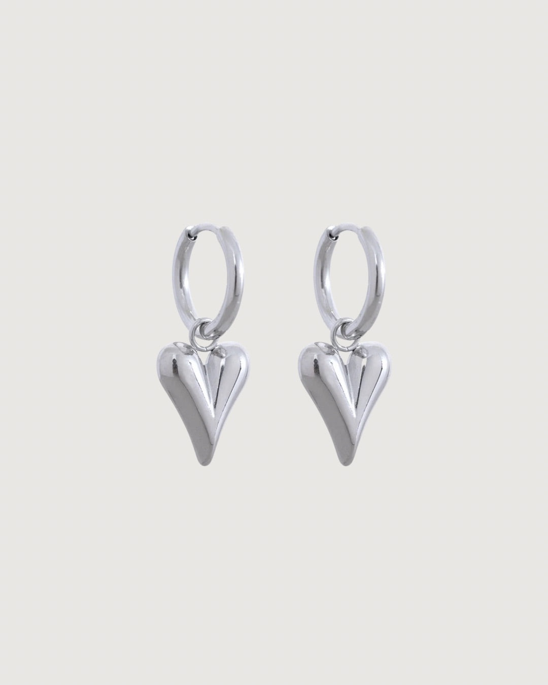 Silver heart charm hoop earrings by Tegan Rae Jewellery featuring elegant hoop design with delicate heart accents.