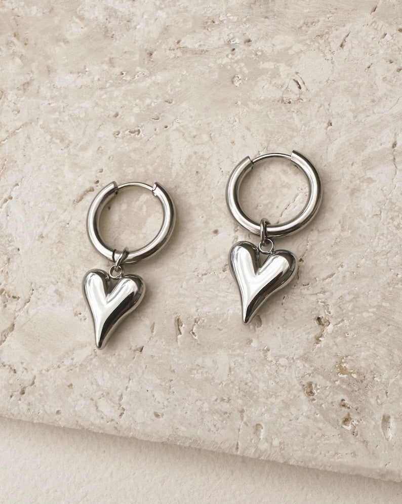 Silver heart charm hoop earrings by Tegan Rae Jewellery, featuring elegant hoop design with dainty heart accents.