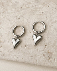 Thumbnail for Silver heart charm hoop earrings by Tegan Rae Jewellery, featuring elegant hoop design with dainty heart accents.