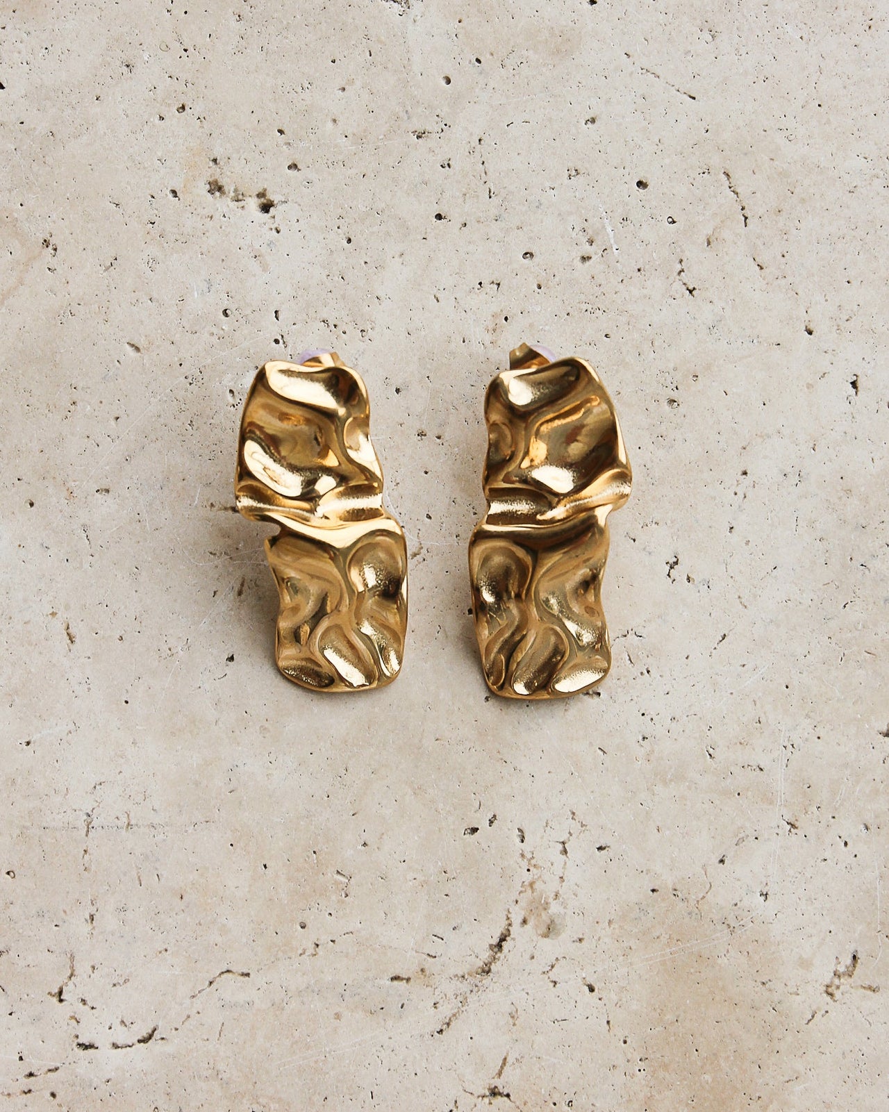 Gold textured stud earrings by Tegan Rae Jewellery, close-up of the small, round, textured surface on the earrings.
