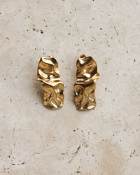 Thumbnail for Gold textured stud earrings by Tegan Rae Jewellery, close-up of the small, round, textured surface on the earrings.
