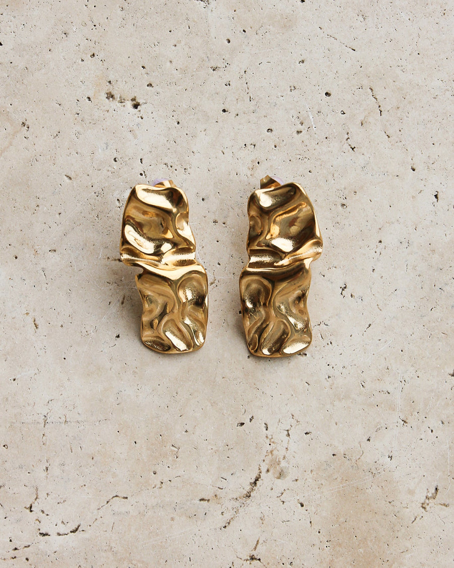Gold textured stud earrings by Tegan Rae Jewellery, close-up of the small, round, textured surface on the earrings.