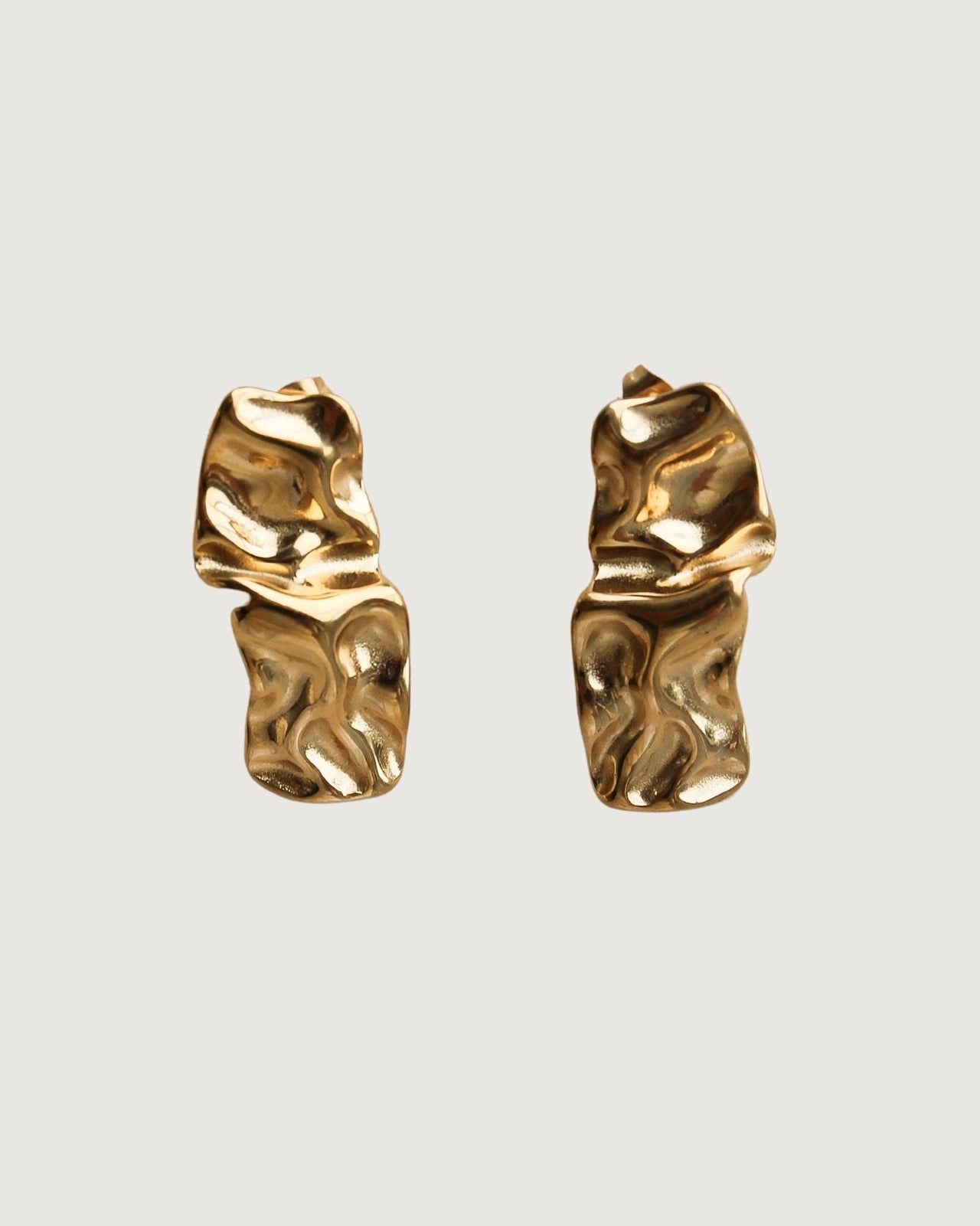 Gold textured stud earrings from Tegan Rae Jewellery, close-up view of the small, round, stud earrings with a textured finish.