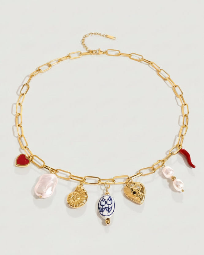 Tegan Rae Jewellery charm necklace featuring a chilli, shell, porcelain bead, pearl, and heart pendant.