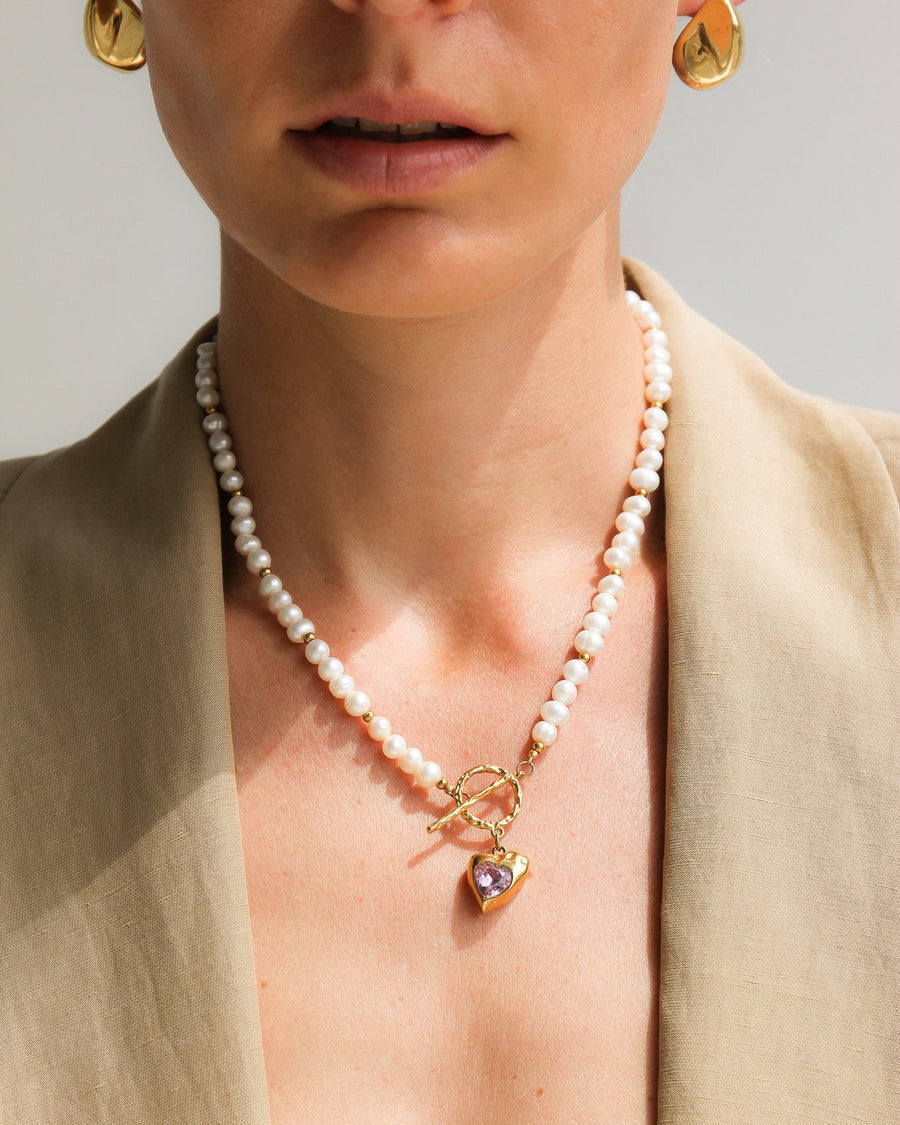 Gold heart-shaped freshwater pearl necklace with pink stone accents by TEGAN RAE JEWELLERY, elegant jewelry for special occasions.
