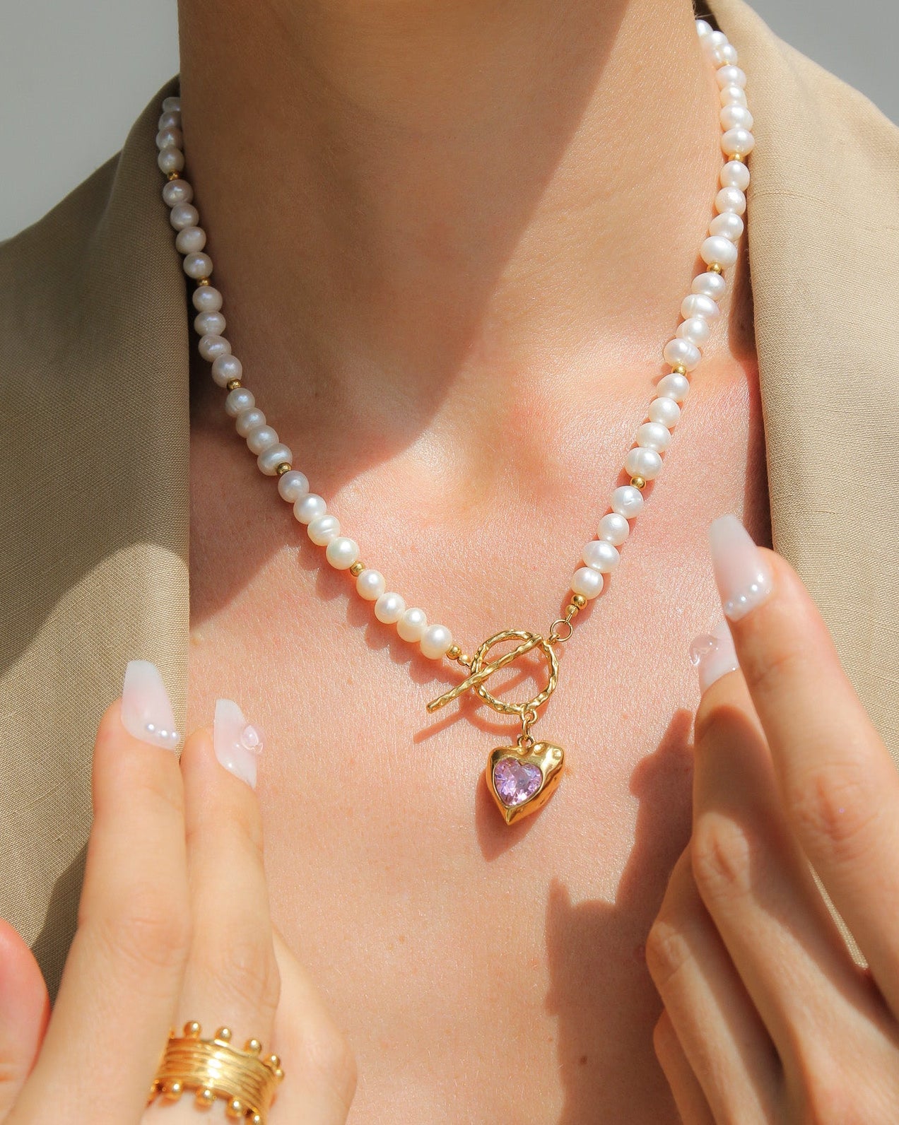 Gold heart necklace with freshwater pearls and pink stone, by Tegan Rae Jewellery, featuring elegant jewelry design.