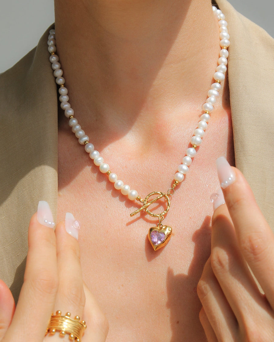 Gold heart necklace with freshwater pearls and pink stone, by Tegan Rae Jewellery, featuring elegant jewelry design.