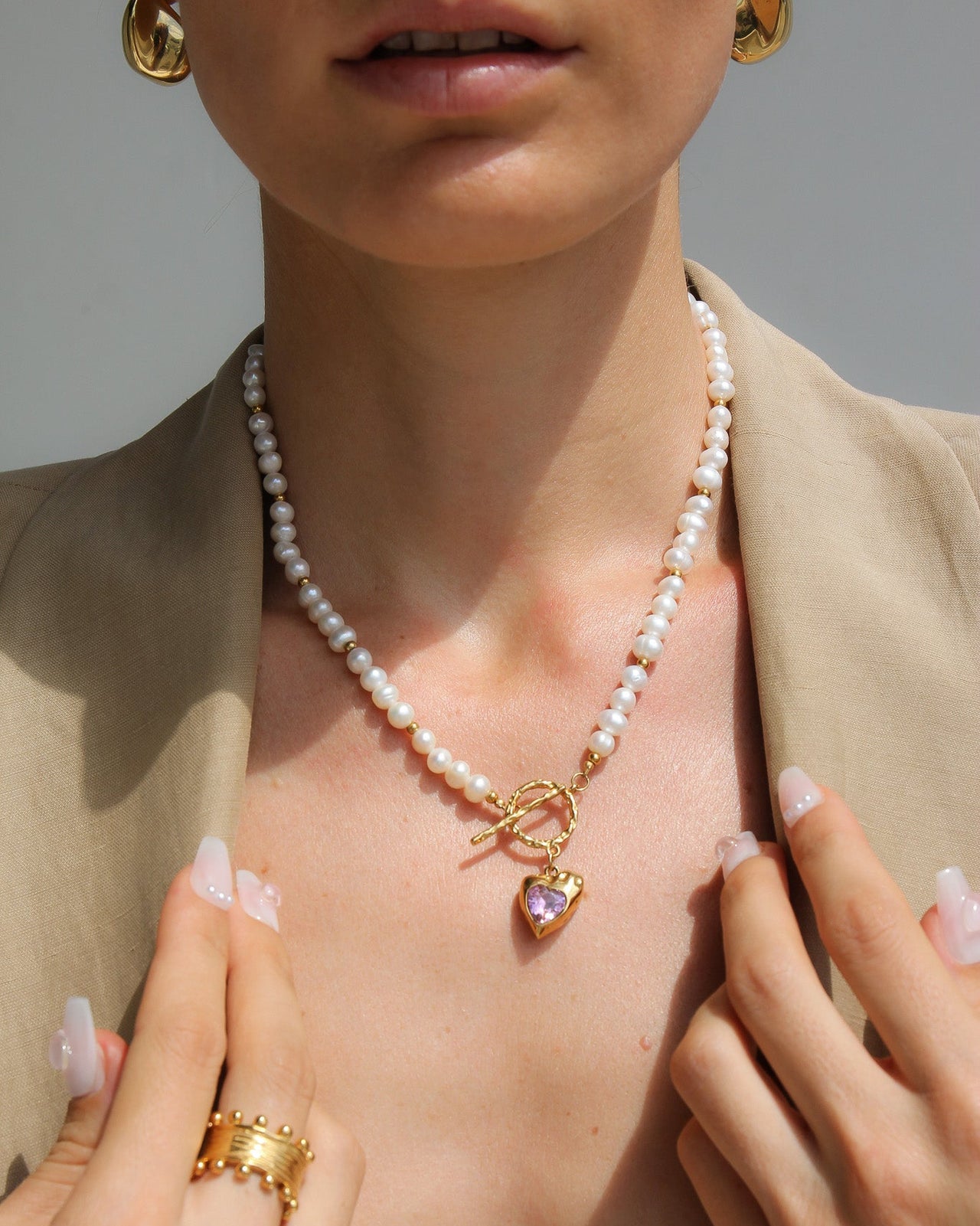 Gold heart necklace by Tegan Rae Jewellery featuring fresh water pearls and pink stones, elegant jewelry for special occasions.
