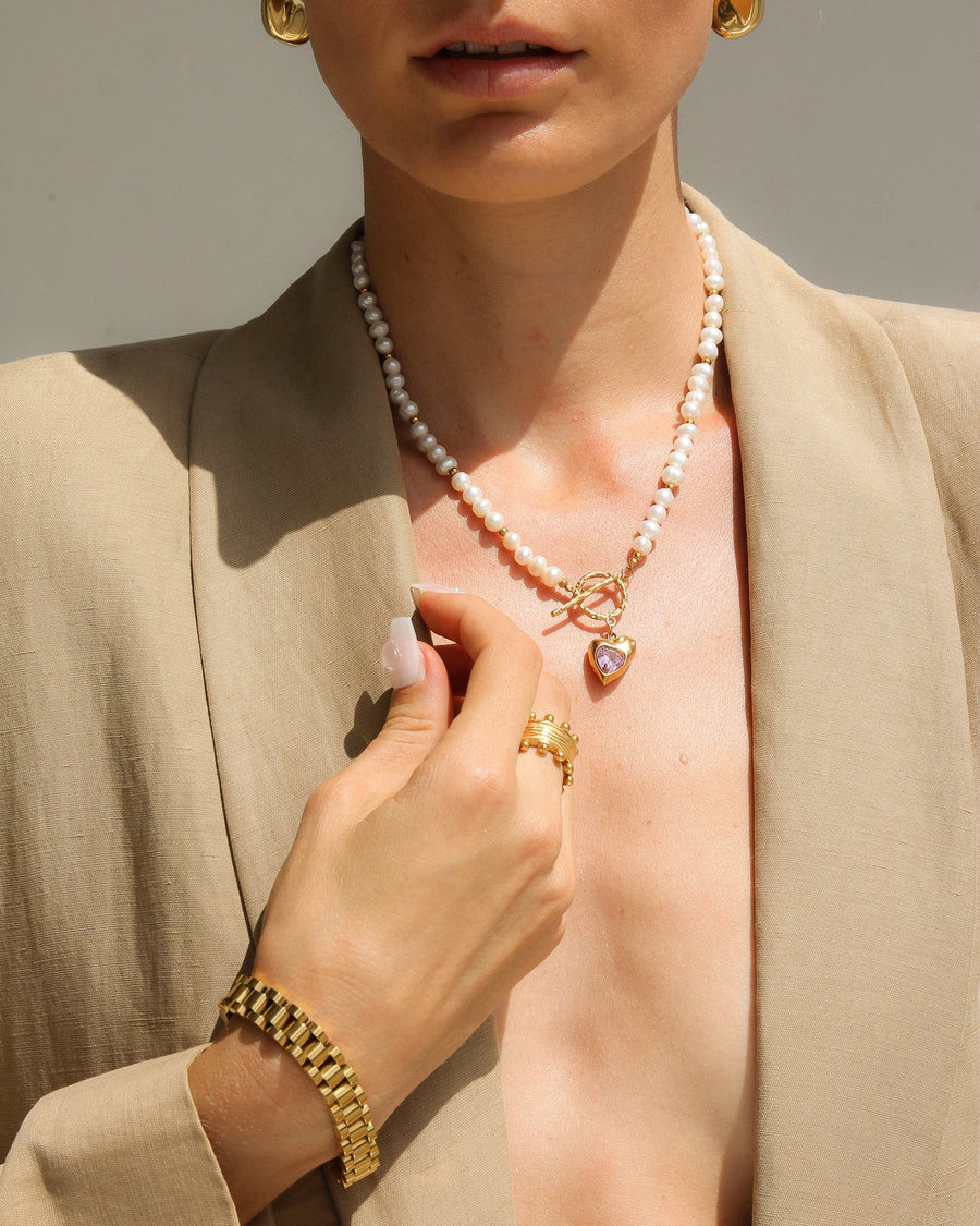 Gold heart-shaped freshwater pearl necklace with pink stone accents by TEGAN RAE JEWELLERY, featuring elegant jewelry design.