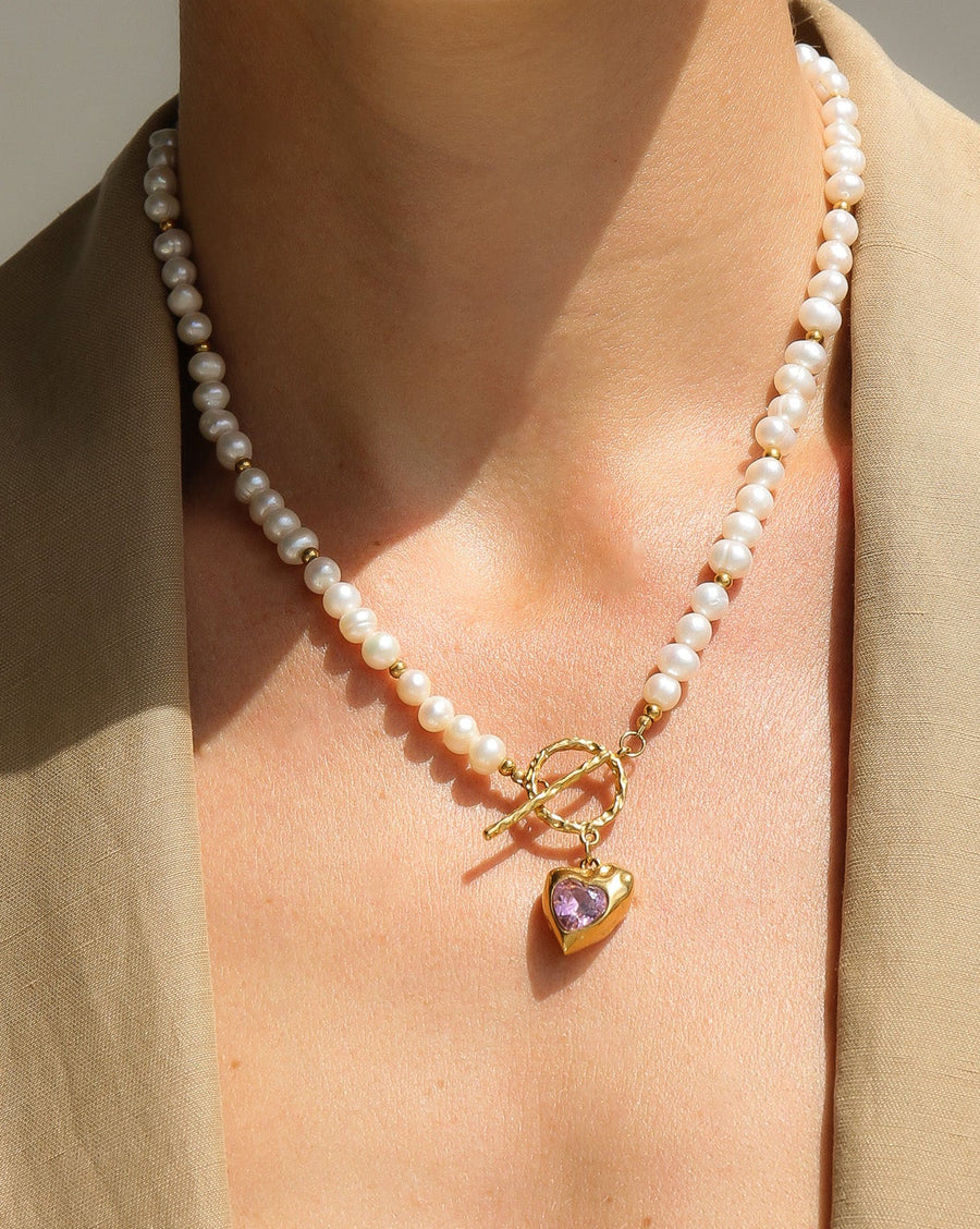 Gold heart-shaped freshwater pearl necklace with pink stone accents from Tegan Rae Jewellery, elegant and romantic jewelry piece.