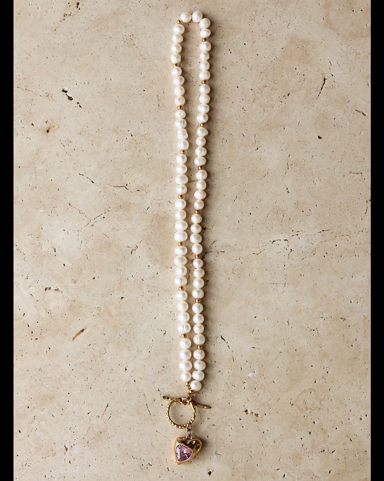 Gold heart freshwater pearl necklace with pink stone, featuring a delicate chain and elegant jewelry design by TEGAN RAE JEWELLERY