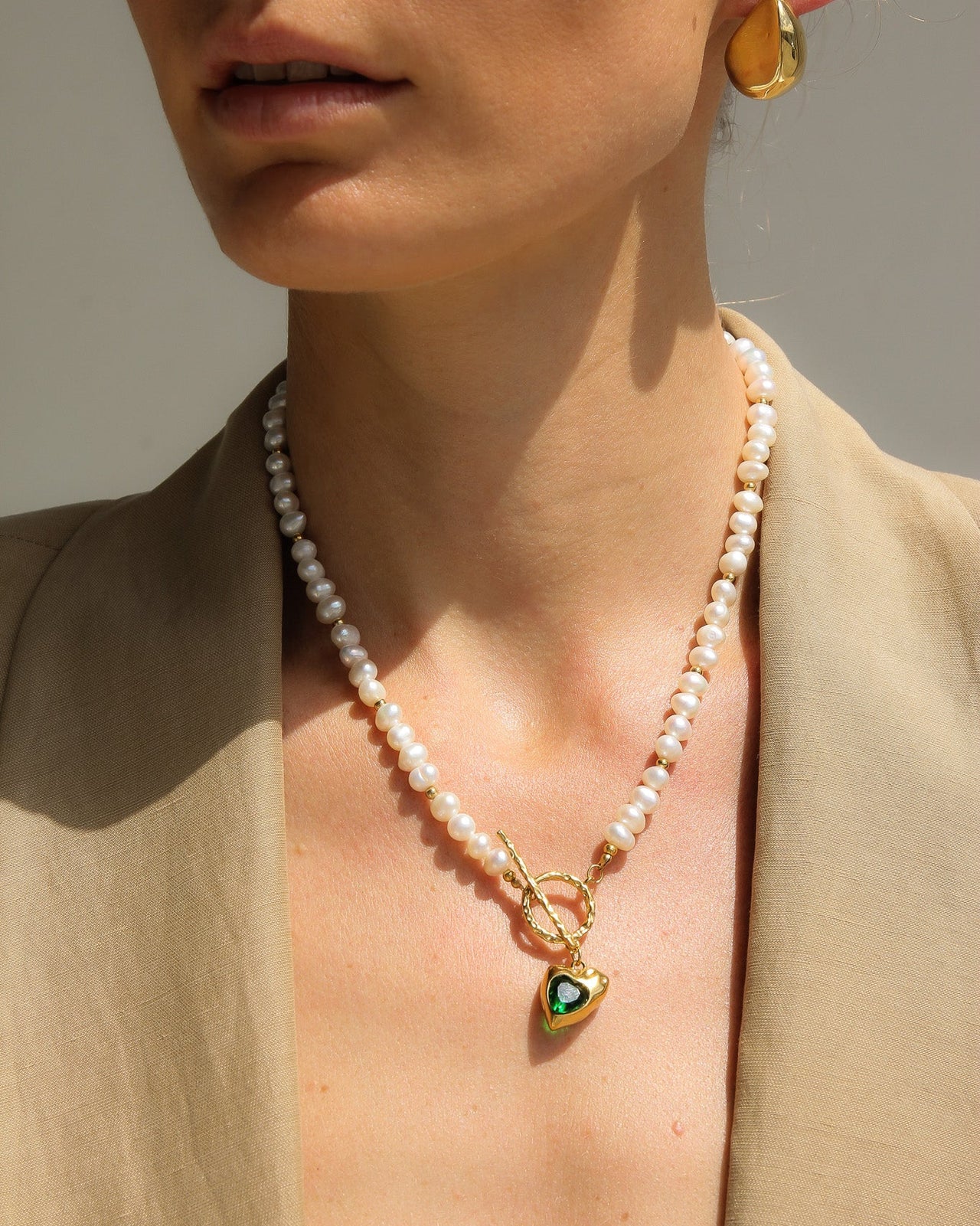 Gold heart freshwater pearl necklace with emerald green stone, elegant jewelry piece by TEGAN RAE JEWELLERY