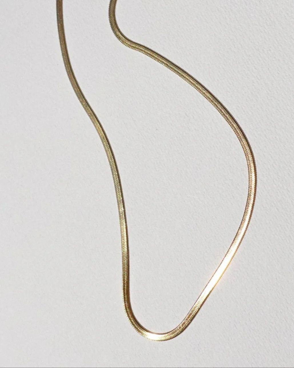 Tegan Rae Jewellery Solace 18k Gold Fine Snake Chain Necklace showcasing a sleek, elegant gold chain design.