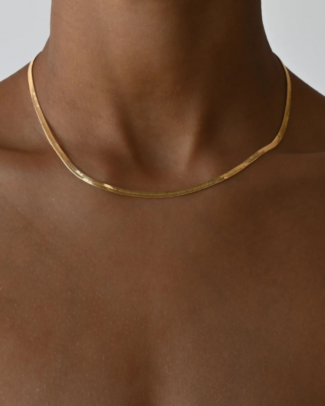Tegan Rae Jewellery Solace fine snake chain necklace in 18k gold, close-up view of sleek, elegant jewelry with a smooth finish.