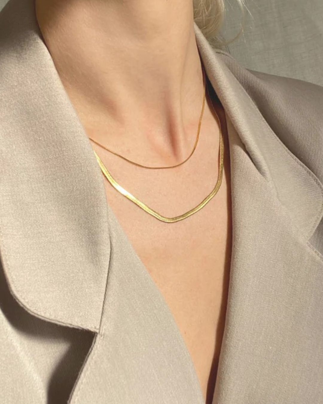 Tegan Rae Jewellery Solace fine snake chain necklace in 18k gold, close-up of the delicate, polished gold jewelry piece.