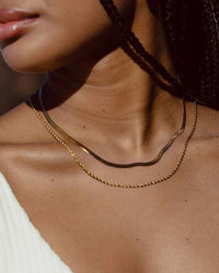 Thumbnail for Tegan Rae Jewellery Solace Fine Snake Chain Necklace in 18k gold, close-up of sleek and elegant gold necklace on a white background