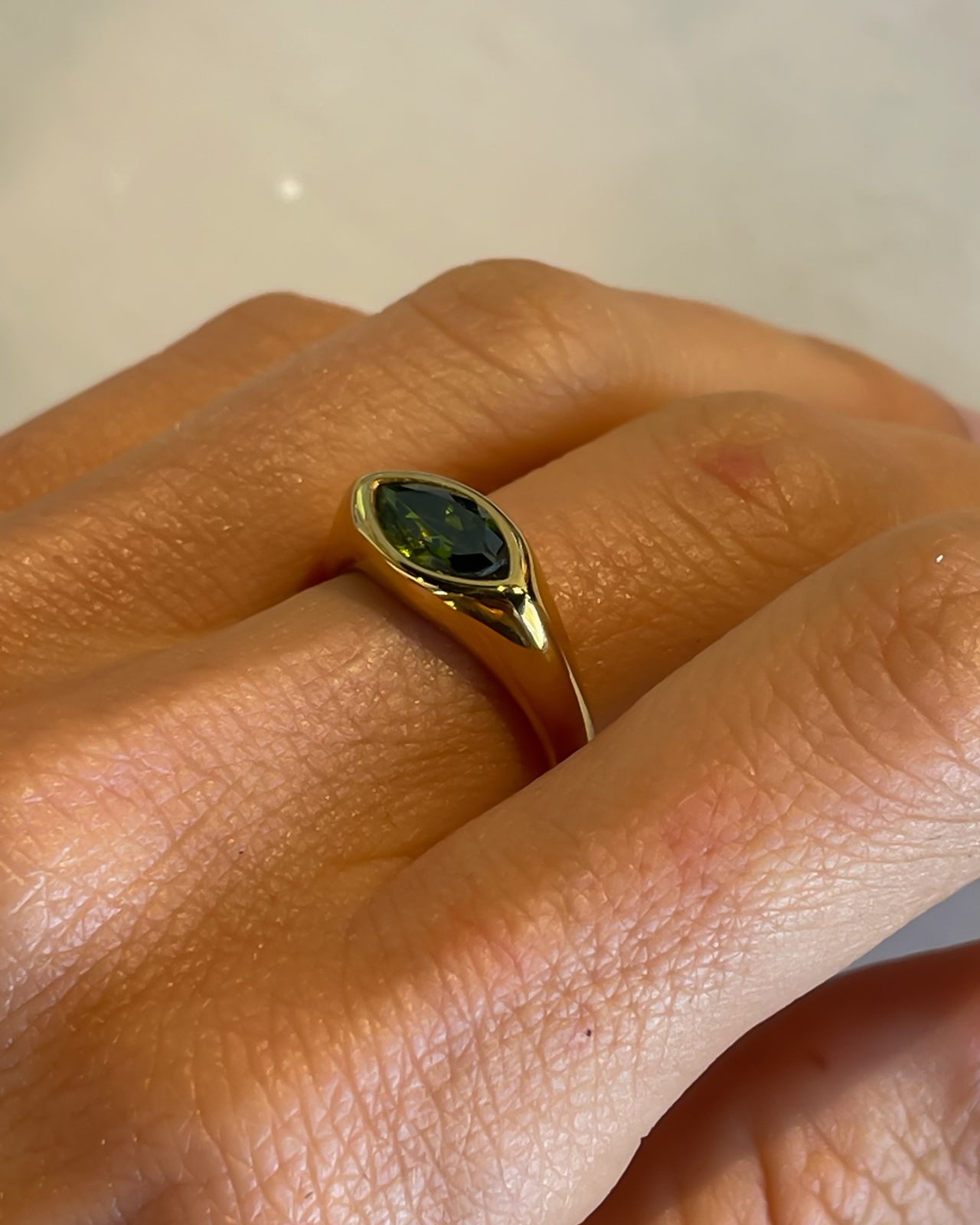Horse eye signet ring with emerald green design in 18k gold PVD finish by Tegan Rae Jewelry.