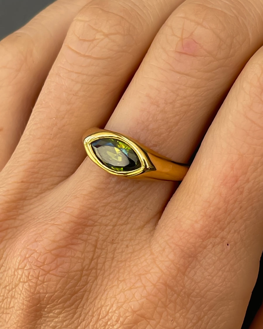 Horse eye signet ring by Tegan Rae Jewelry with emerald green stone in 18k gold PVD finish, showcasing detailed craftsmanship.