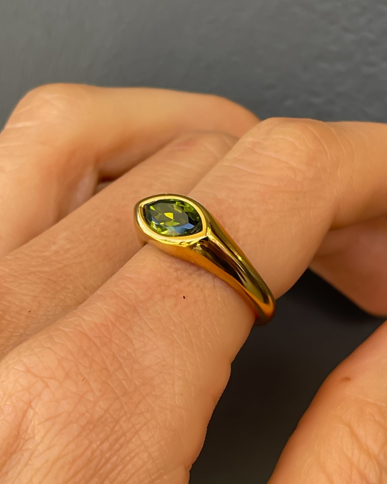 Horse eye signet ring by Tegan Rae Jewelry with emerald green stone in 18k gold PVD finish, showcasing intricate design.