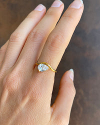 Thumbnail for Gold ring with a diamond on a hand against a dark background