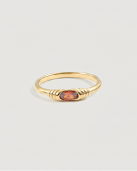 Thumbnail for Gold ring with a red gemstone on a light gray background
