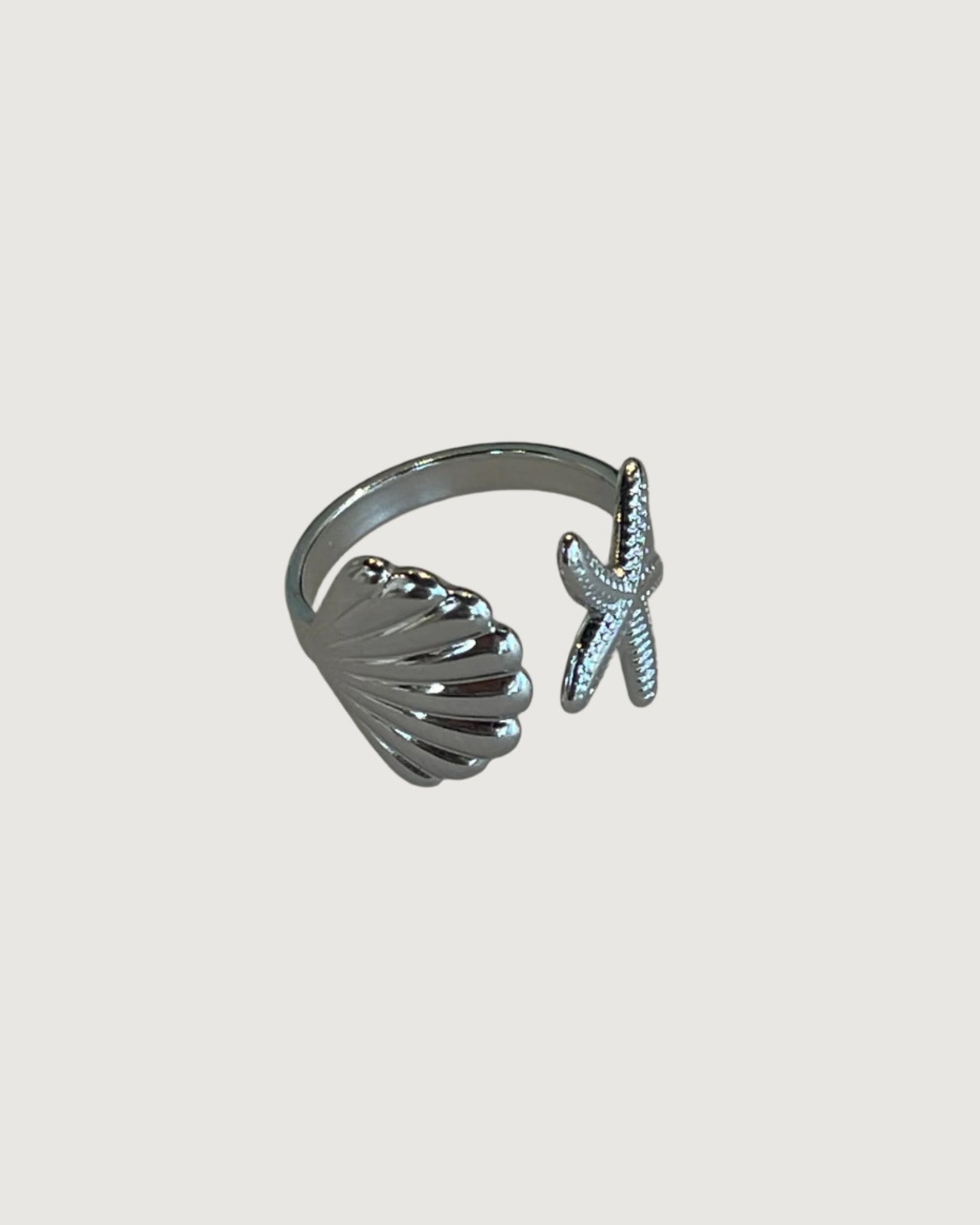 Tegan Rae Jewellery starfish shell tidal charm open ring in platinum silver with intricate ocean-inspired design.