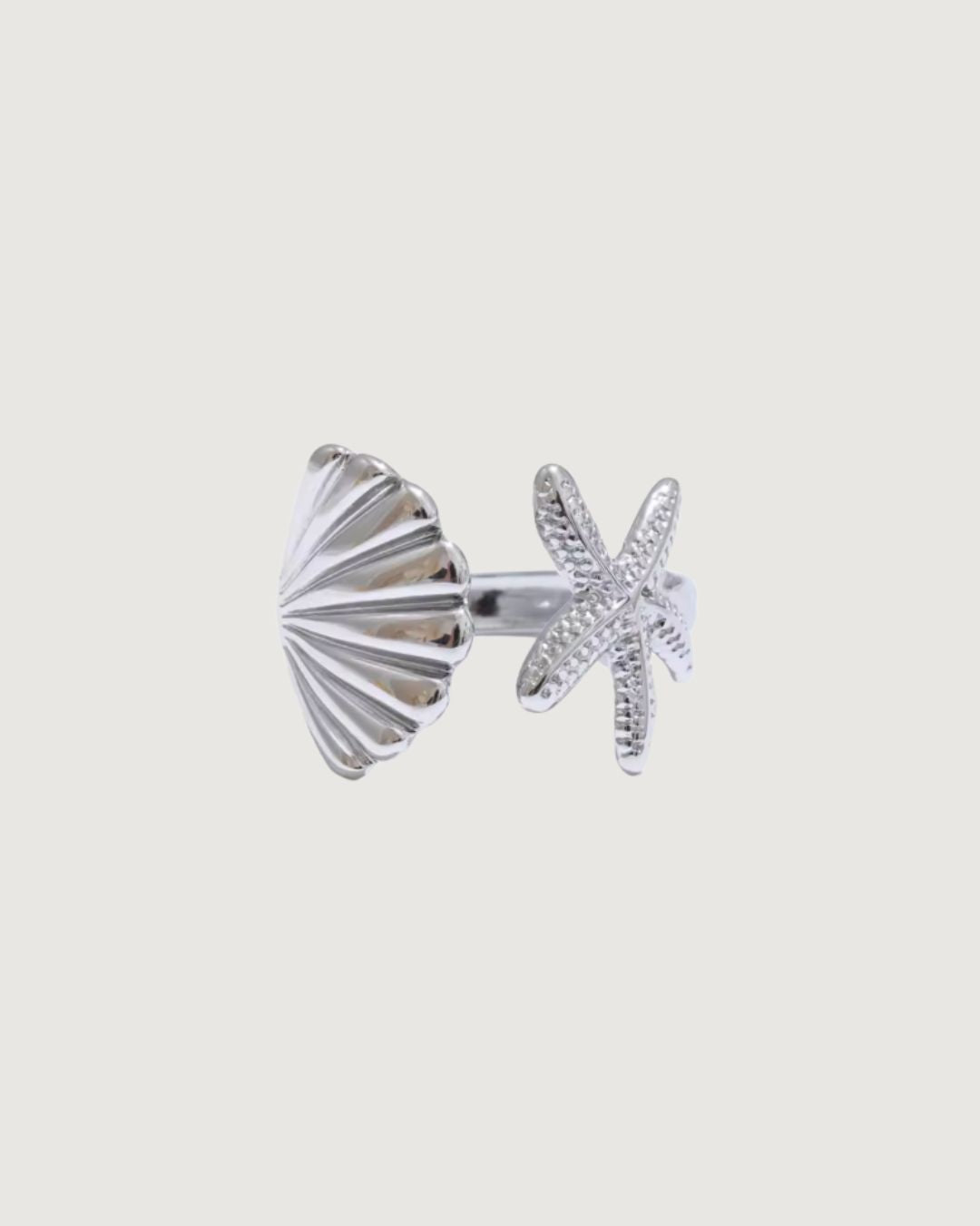 Open starfish shell tidal charm ring in platinum silver by TEGAN RAE JEWELLERY, featuring intricate sea-inspired design.