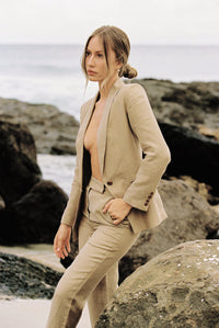 Thumbnail for Woman wearing a taupe blazer and trouser by the beach