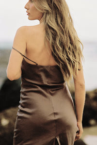 Thumbnail for Close-up of woman wearing a brown silk slip dress from behind