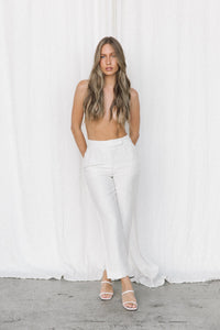 Thumbnail for Model wearing white linen trousers posing in a studio