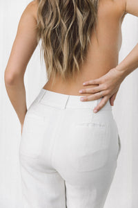 Thumbnail for Close-up of back pocket details on white linen trousers