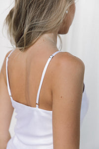 Thumbnail for Close-up of woman wearing a white silk camisole with adjustable straps