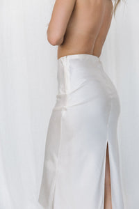 Thumbnail for Close-up of model wearing cream silk slip skirt posing in a studio