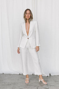 Thumbnail for Model wearing white linen suit posing in a studio