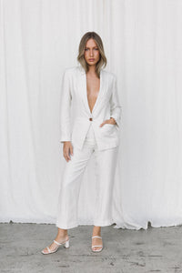 Thumbnail for Model wearing a white linen suit posing in a studio