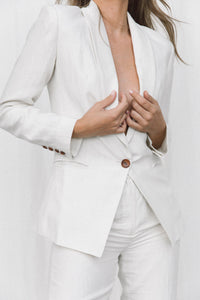 Thumbnail for Close-up of model wearing a white linen suit posing in a studio