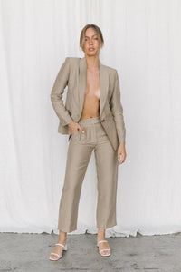 Thumbnail for Model wearing a taupe blazer and trouser in a studio