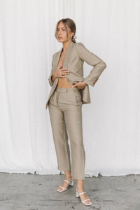 Thumbnail for Model wearing a taupe linen blazer and trouser posing in a studio